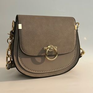 Taupe shoulder bag with additional adjustable crossbody strap.